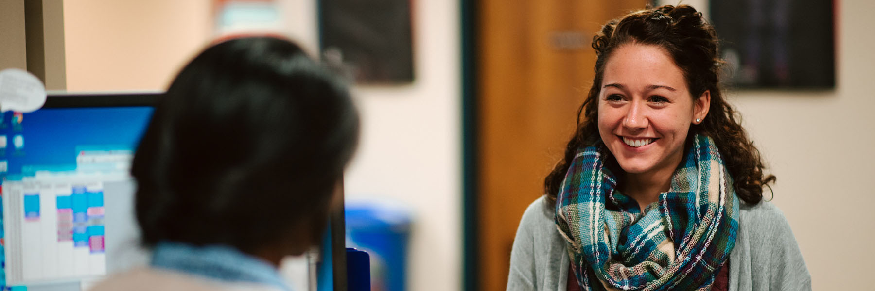 A student discussing her schedule with her mentor.